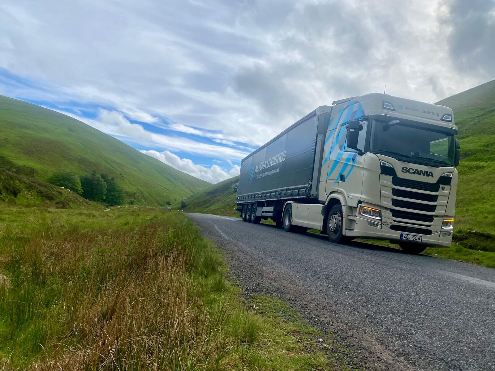 Alvora Logistics white Scania with black curtain-side trailer on a UK road route